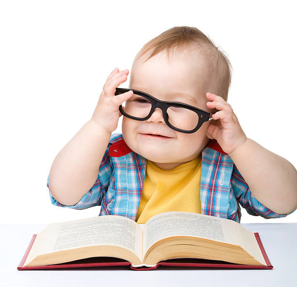istock Little child play with book and glasses 122205645
