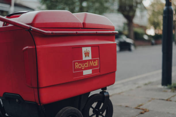 Red delivery troll belonging to Royal Mail on a street in London, UK. stock photo