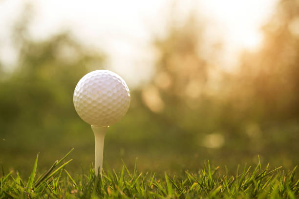 istock golf ball on tee in a beautiful golf course 1222056951