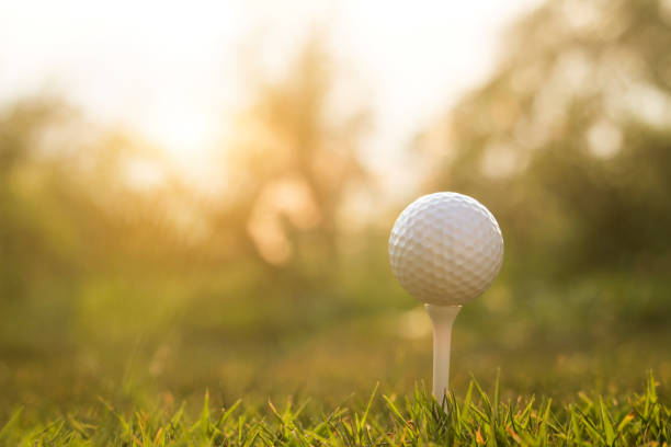 istock golf ball on tee in a beautiful golf course 1222056982