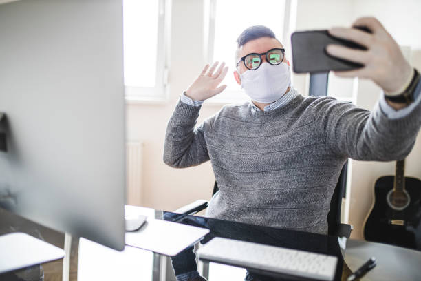 istock Businessman using phone and wearing protective face-mask and surgical glove 1222057747