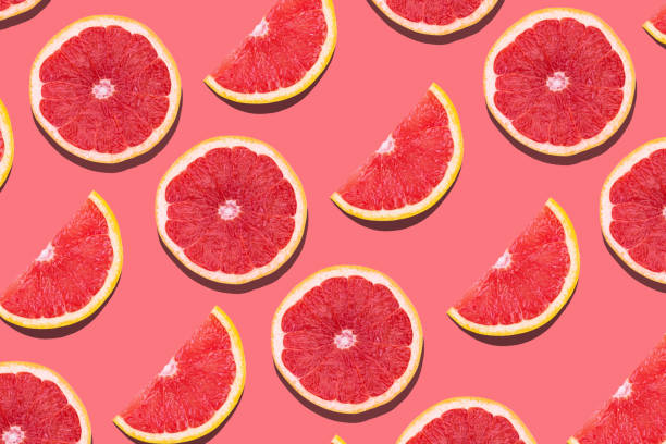 istock Fresh red orange or grapefruit on a peach color background. 1222066650