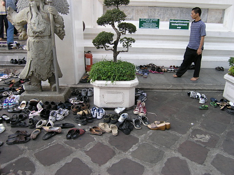 Bangkok, Thailand - January 2005: Shoes outside Wat Po (The Temple of the Reclining Buddha) in Bangkok, Thailand