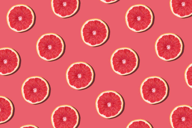 istock Fresh red orange or grapefruit on a peach color background. 1222066691