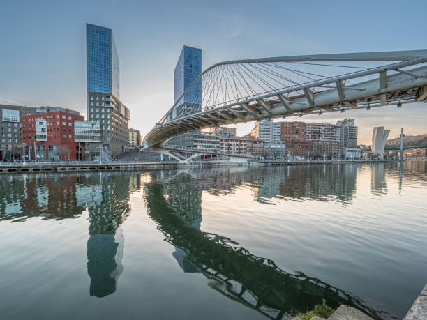 istock twin skyscrapers with white bridge spanning a river 1222068108