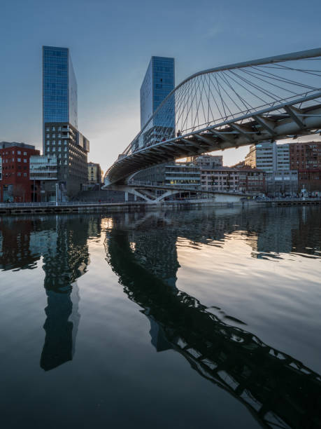 istock twin skyscrapers with white bridge spanning a river 1222068127