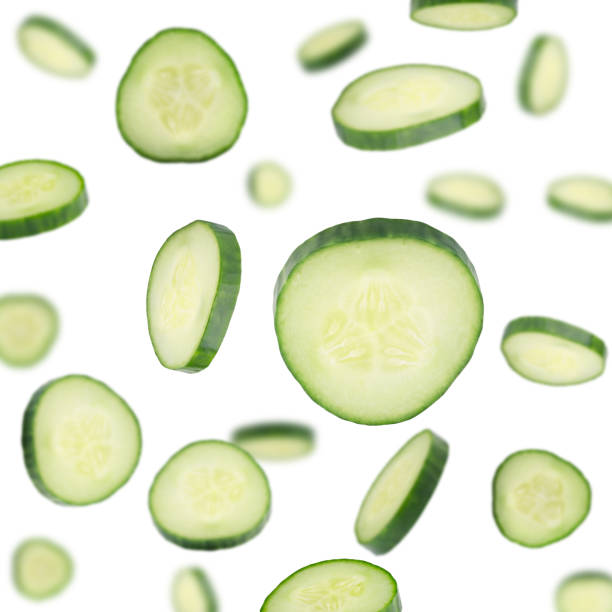Cucumber Slices Flying in Air on White Background. Set of Close Up Sliced Cucumber Cucumber Slices Flying in Air on White Background. Set of Falling Cut Fresh Cucumber Close Up. Green Delicious Vegetable Cut For Salad. Healthy Food, Nutrition and Diet Concept cucumber slice stock pictures, royalty-free photos & images