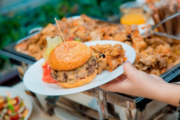 istock plate with burger and pilaf in hand 1222070440