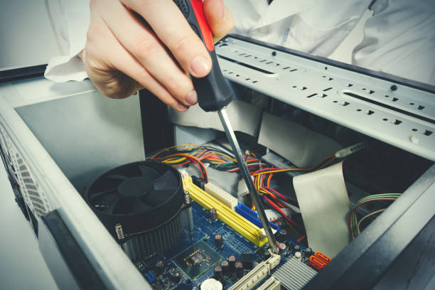 istock Close-up on the hands with screwdriver tool of the technician repairing a PC computer 1222070791