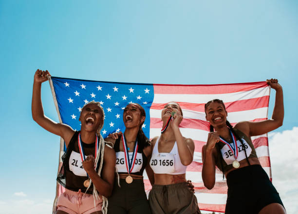istock Group of winning US athletes with national flag 1222070960