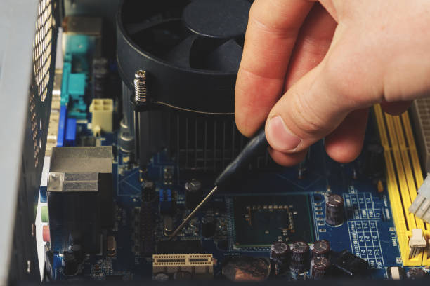 istock Close-up on the hands with screwdriver tool of the technician repairing a PC computer 1222070961