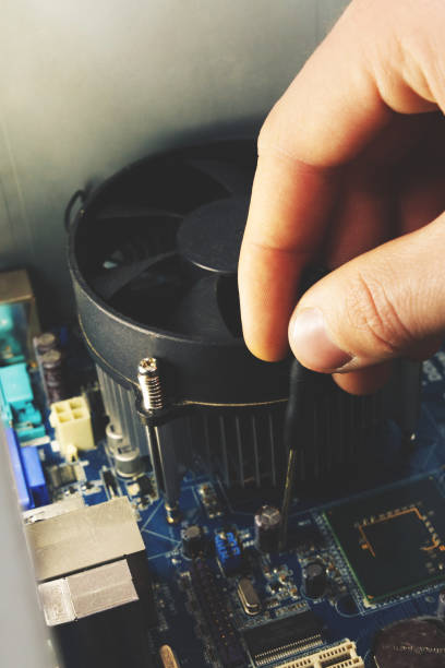 istock Close-up on the hands with screwdriver tool of the technician repairing a PC computer 1222071006