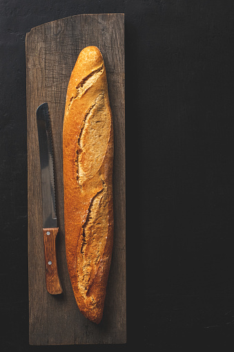 Crunchy french baguette and kitchen knife.