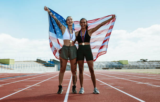 istock Runners celebrating on track with american flag 1222071049