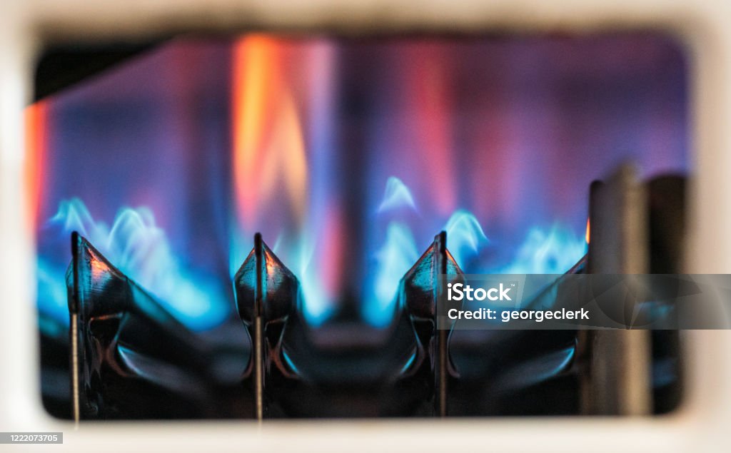 Gas heating boiler flames Flames ignited to heat water as seen through a gas boiler's viewing window. Natural Gas Stock Photo