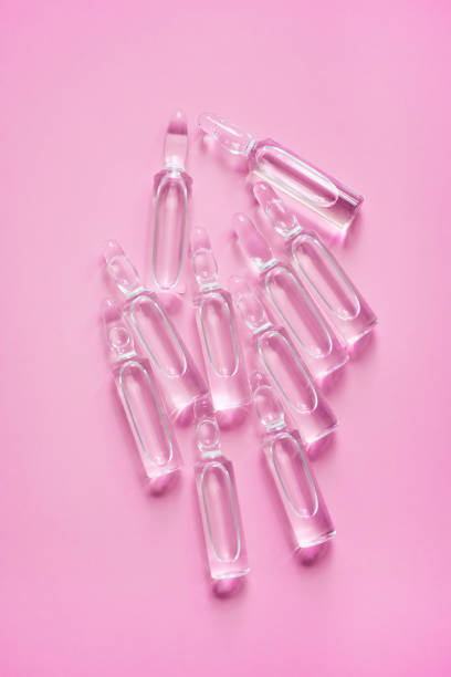 istock Ampoules with medicine on pink background. Pharmaceutical, cure 1222076936