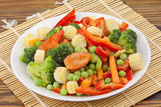 istock Frozen vegetables gorse or tomatoes corn peas bell peppers carrots on plate 1222078170