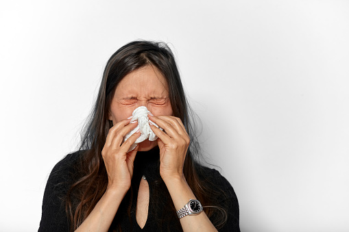 Portrait of a mature woman feeling sick due to an allergie