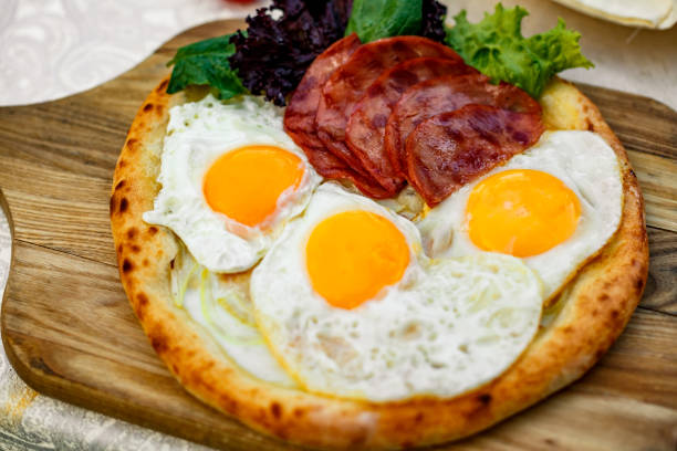 istock Bacon and eggs on a wheat cake with greens for lunch 1222082664