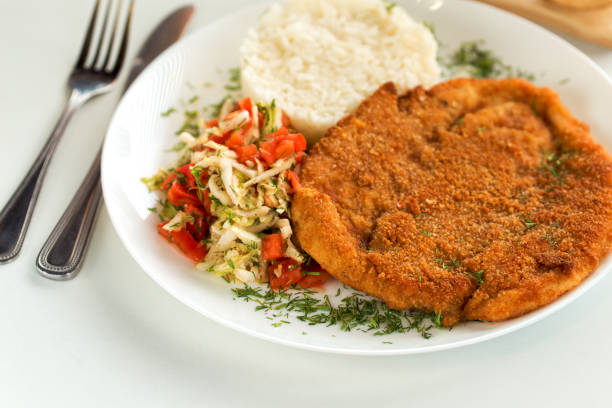 istock German schnitzel with rice and cabbage salad 1222083024
