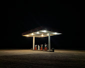 An Empty Filling Station under an Illuminated Awning at Night Surrounded by Complete Darkness