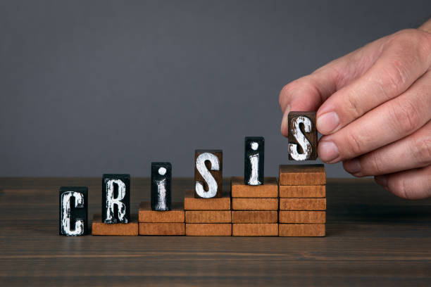 istock CRISIS concept. Wooden alphabet letters on steps 1222084705