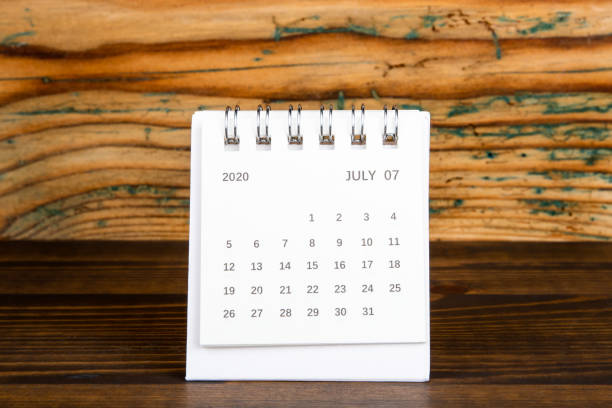 istock 2020 July. White paper calendar on a wooden table 1222084710