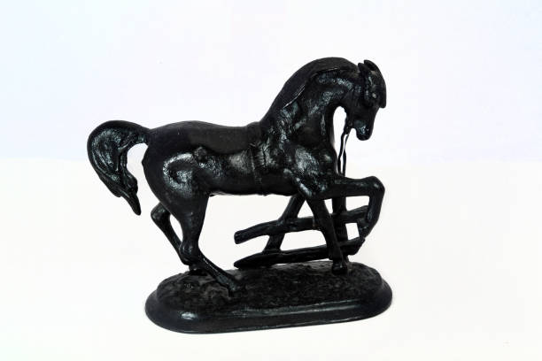 Cast-iron horse figurine isolate on a white background close-up.