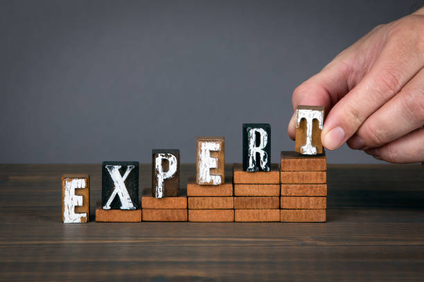 istock EXPERT concept. Wooden alphabet letters on steps 1222084741