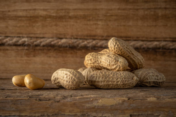 istock Peanut in a shell on wooden background. Food background. Top view. 1222084752