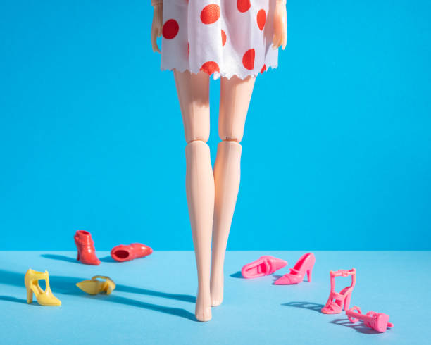 istock Doll legs with different shoes on a blue background. Minimal fashion composition. 1222084862
