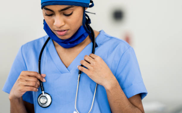istock Ethnic Medical Professional Looking Down Adjusting her Stethoscope 1222085051