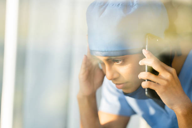 istock Tired Middle Eastern Doctor Taking a Break to Call a Loved One 1222085119