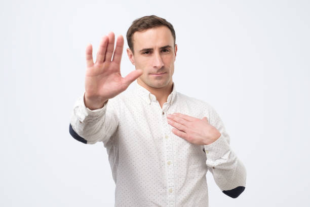 istock Serious young man showing stop gesture. Social distance concept. 1222086296