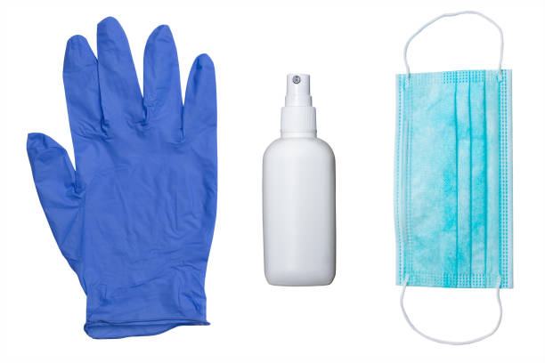 protection glove, alcohol sanitizer and mask on white surface