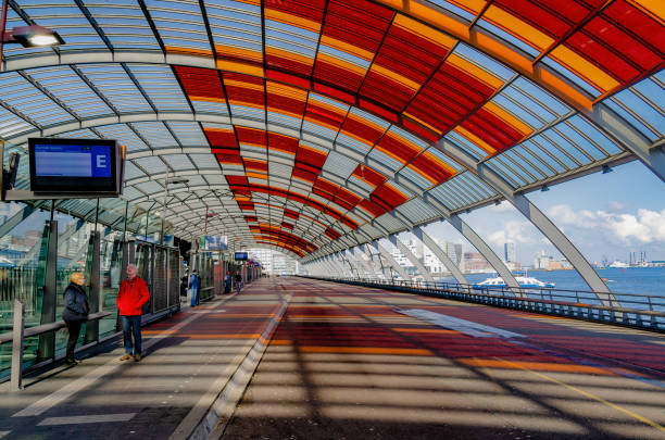 Inside Amsterdam's main transportation hub with view of bicycle parking and light rail system