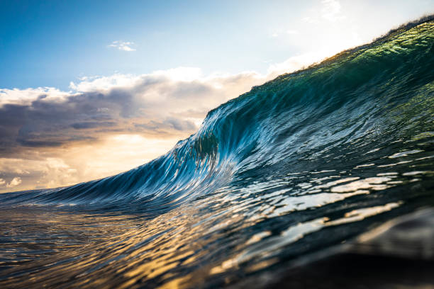 istock Colourful wave breaking in ocean over at sunrise 1222094740