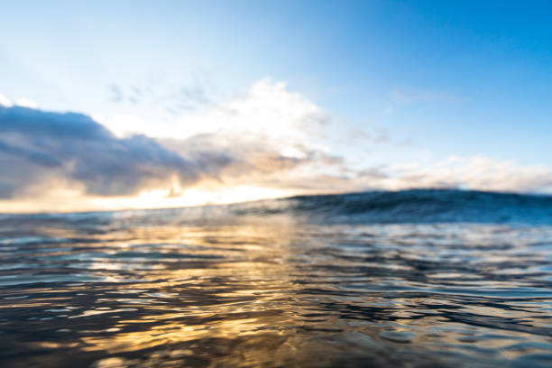 istock Smooth ocean surface at golden sunrise with storm 1222095992