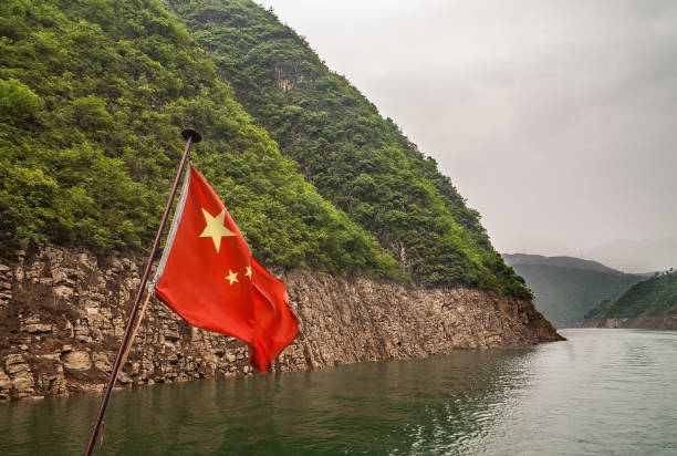 istock Mountainous shoreline with flag on Daning River, Wuchan, China. 1222096076