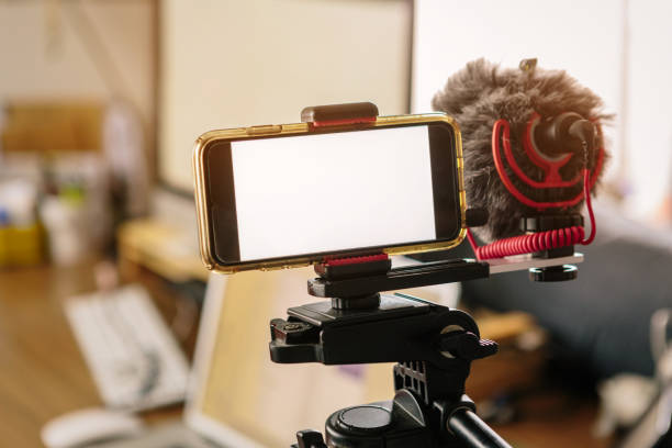 istock smartphones connected to an external microphone and coupled to a tripod. 1222096250