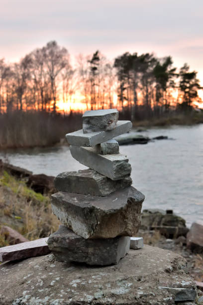 istock Stone tower in the foreground before sunset and large lake 1222096890