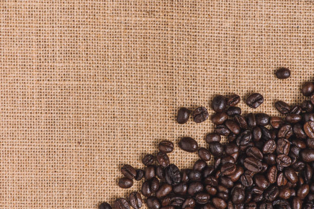 istock Close up roasted coffee beans on sackcloth background with copy space 1222096977