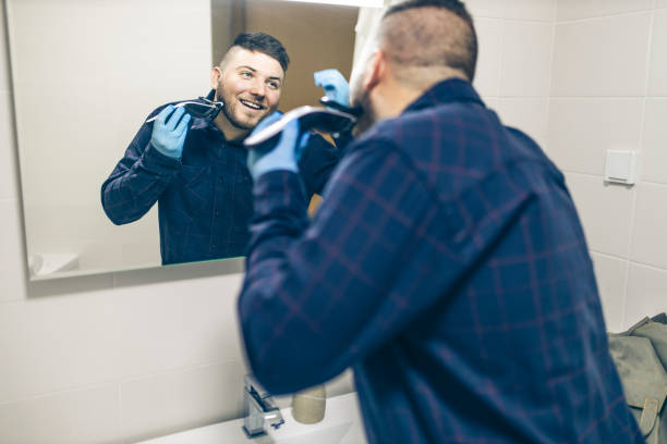 istock Man shaving with electric razor 1222097523