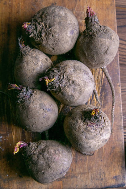 Fresh picked organic beetroot on old rustic wooden board, on wooden background