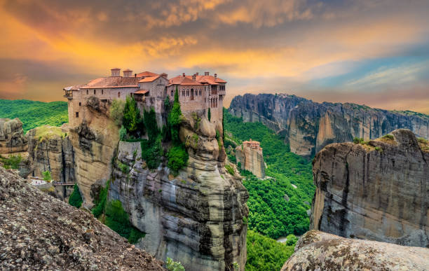 Meteora monastery in Greece Religious Greek monastery inside the site of Meteora village at dusk meteora stock pictures, royalty-free photos & images