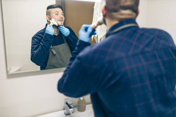 istock Man shaving with electric razor 1222098611