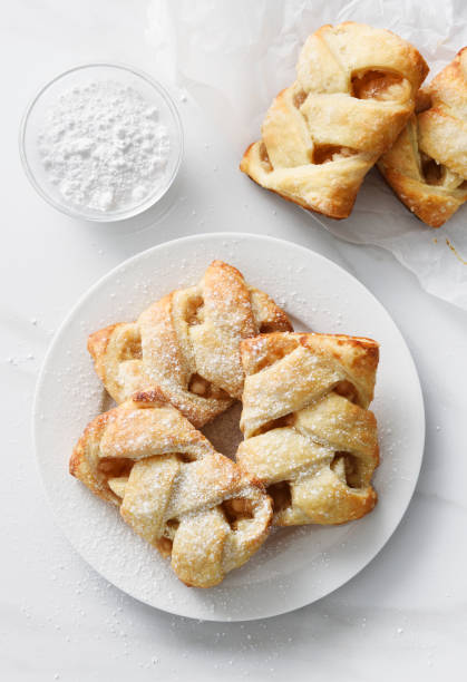 Apple strudel pastry Apple strudel pastry in a white plate on kitchen counter strudel stock pictures, royalty-free photos & images