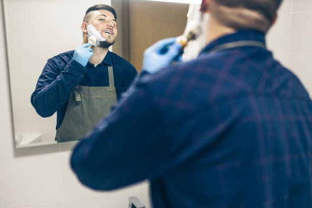 istock Man shaving with brush and cream 1222100094