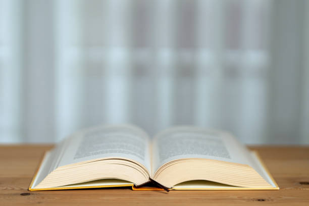 istock A thick book with open hardcover on a wooden floor 1222100755