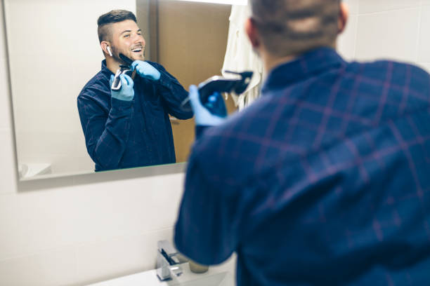 istock Man shaving with electric razor 1222100996
